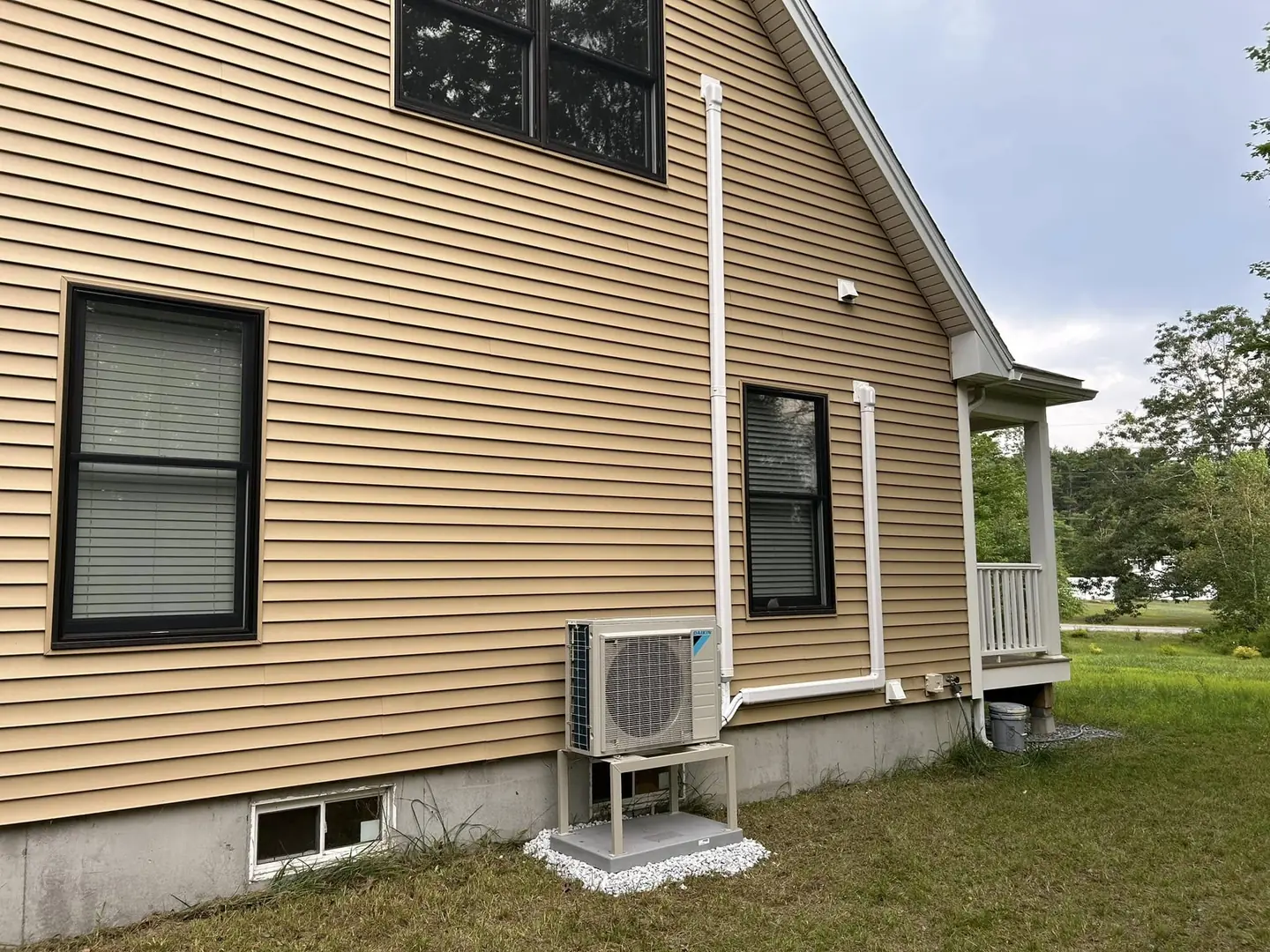 Outdoor ductless heat-pump unit beside a home