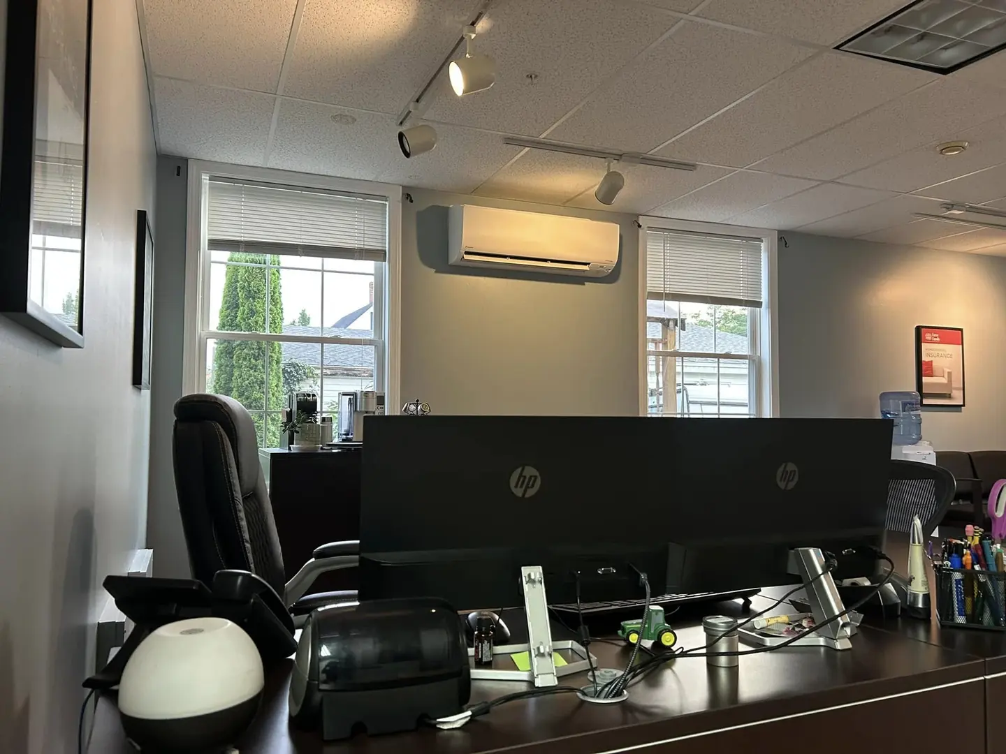 Wall-mounted mini-split above an office workspace
