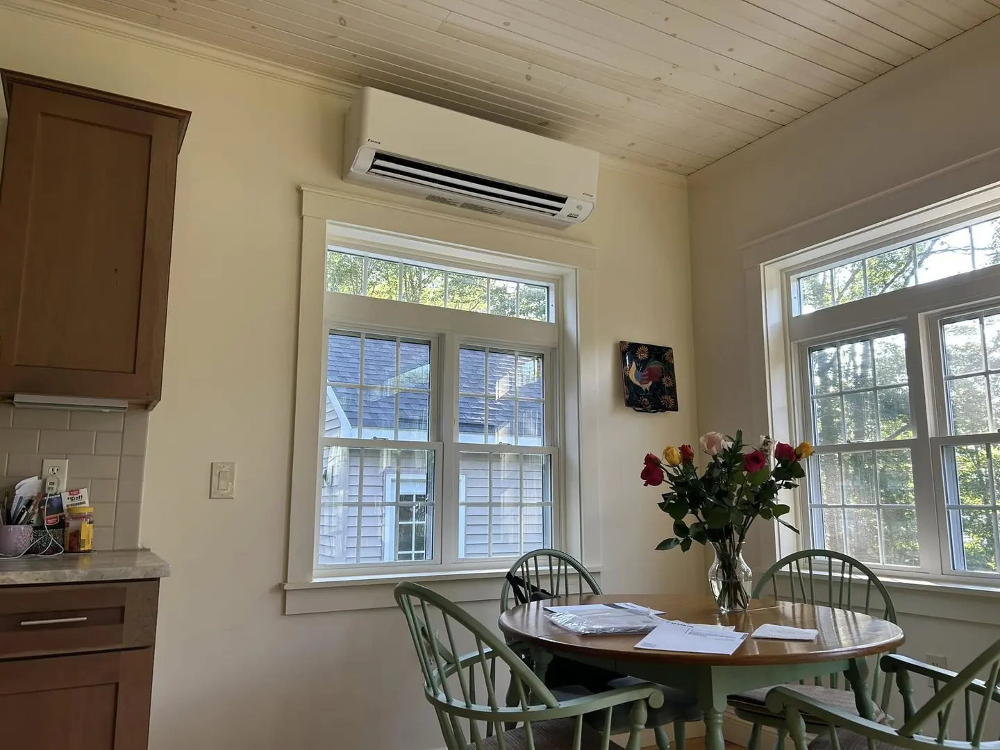 Wall-mounted mini-split below exposed wood ceiling beams