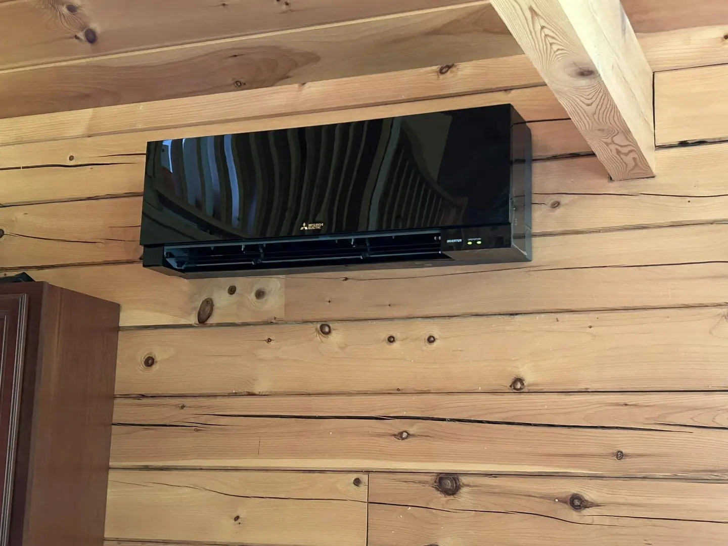 Several heat-pump condensers installed along a home