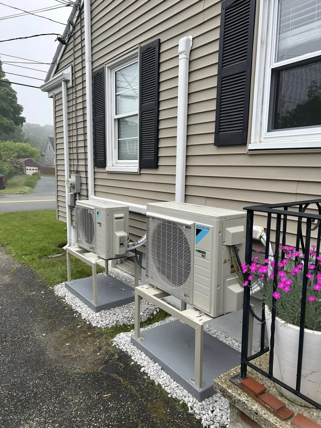 Ductless heat-pump units installed beside a home