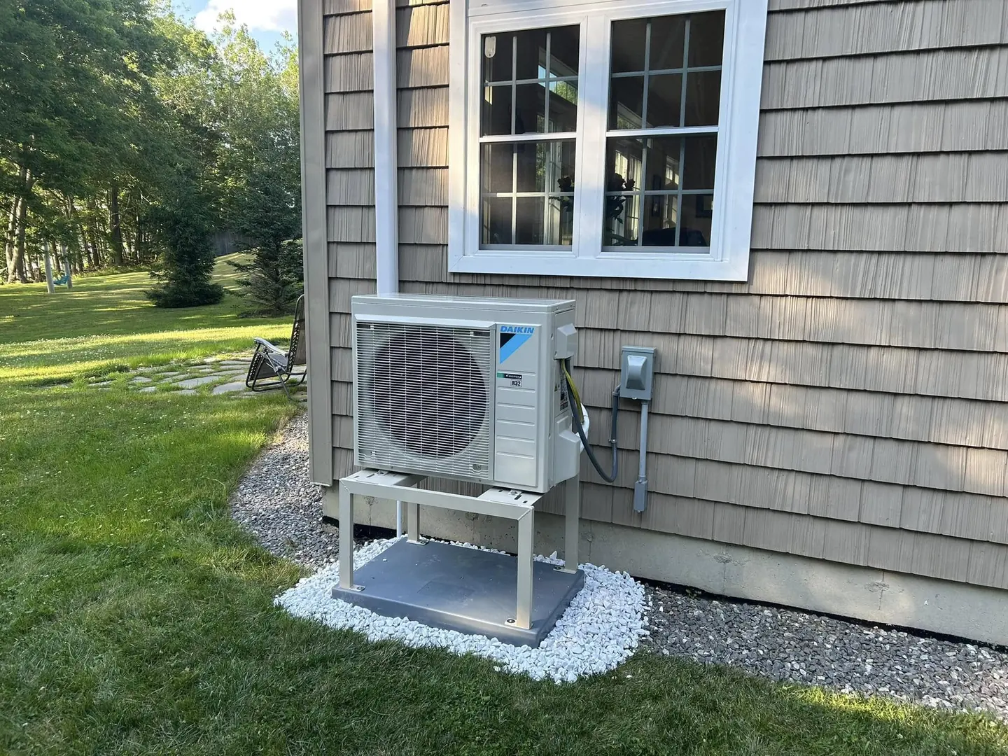 Multiple outdoor units arranged beside a home