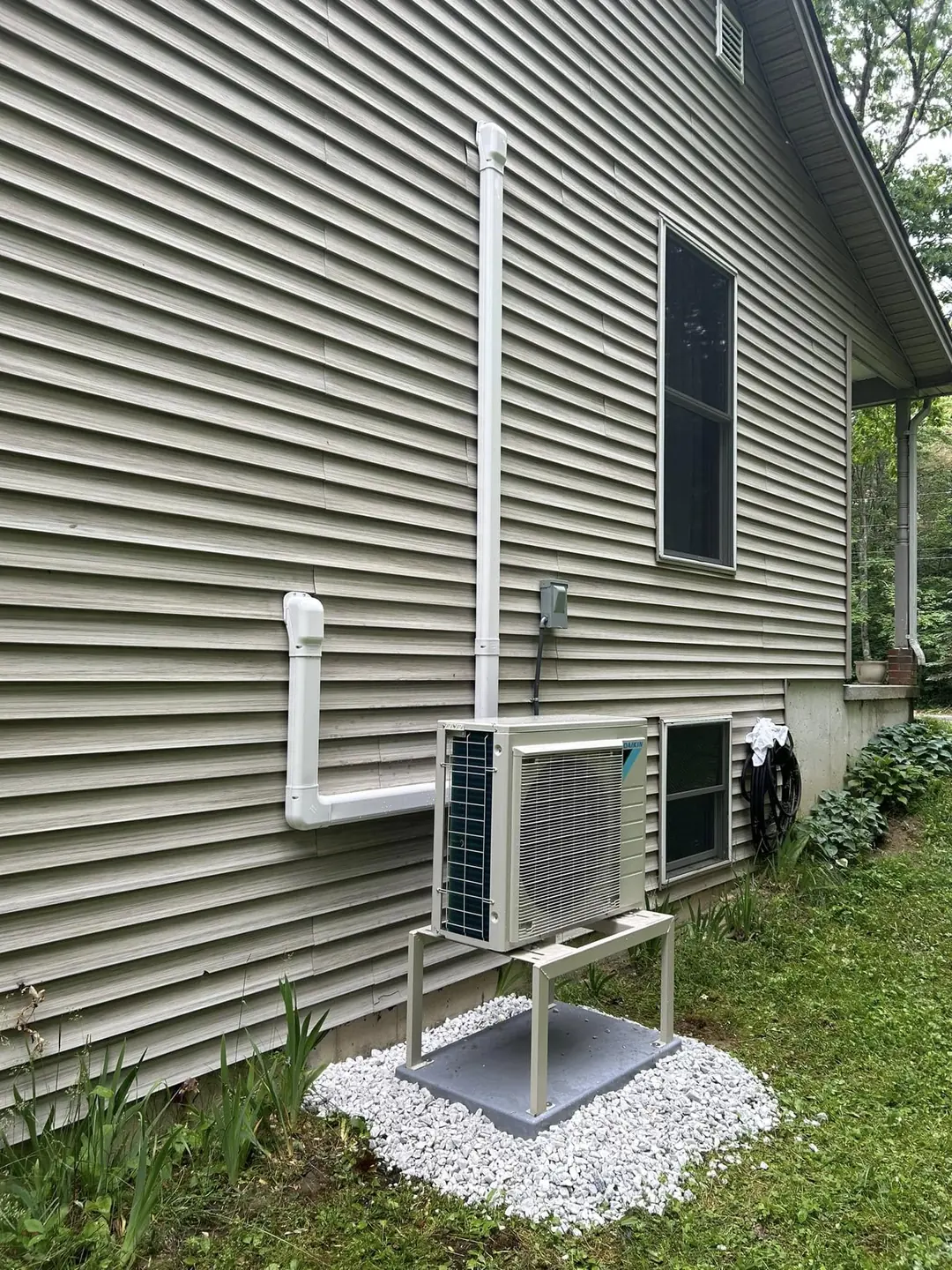 Outdoor heat-pump unit installed beside a home